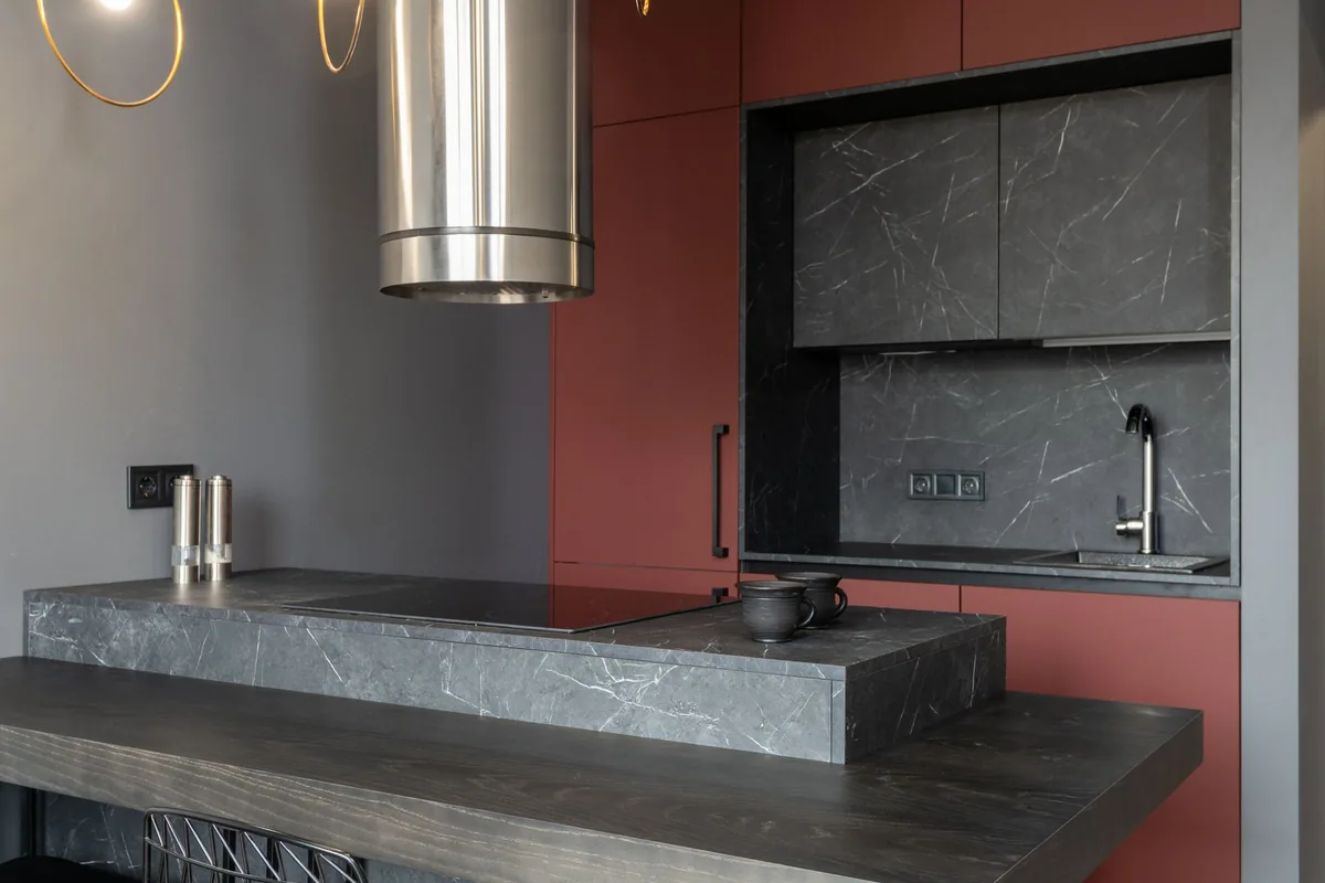 Small open plan kitchen with compact cabinets and counter