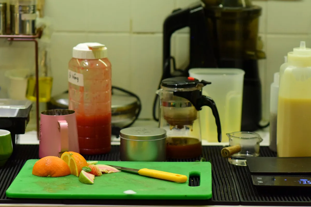 A kitchen counter with citrus fruit and juice