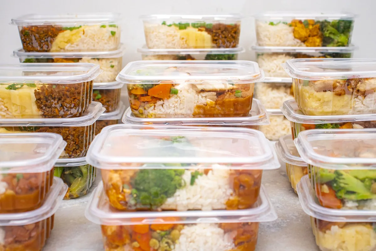 Several containers of prepared meals with rice and vegetables