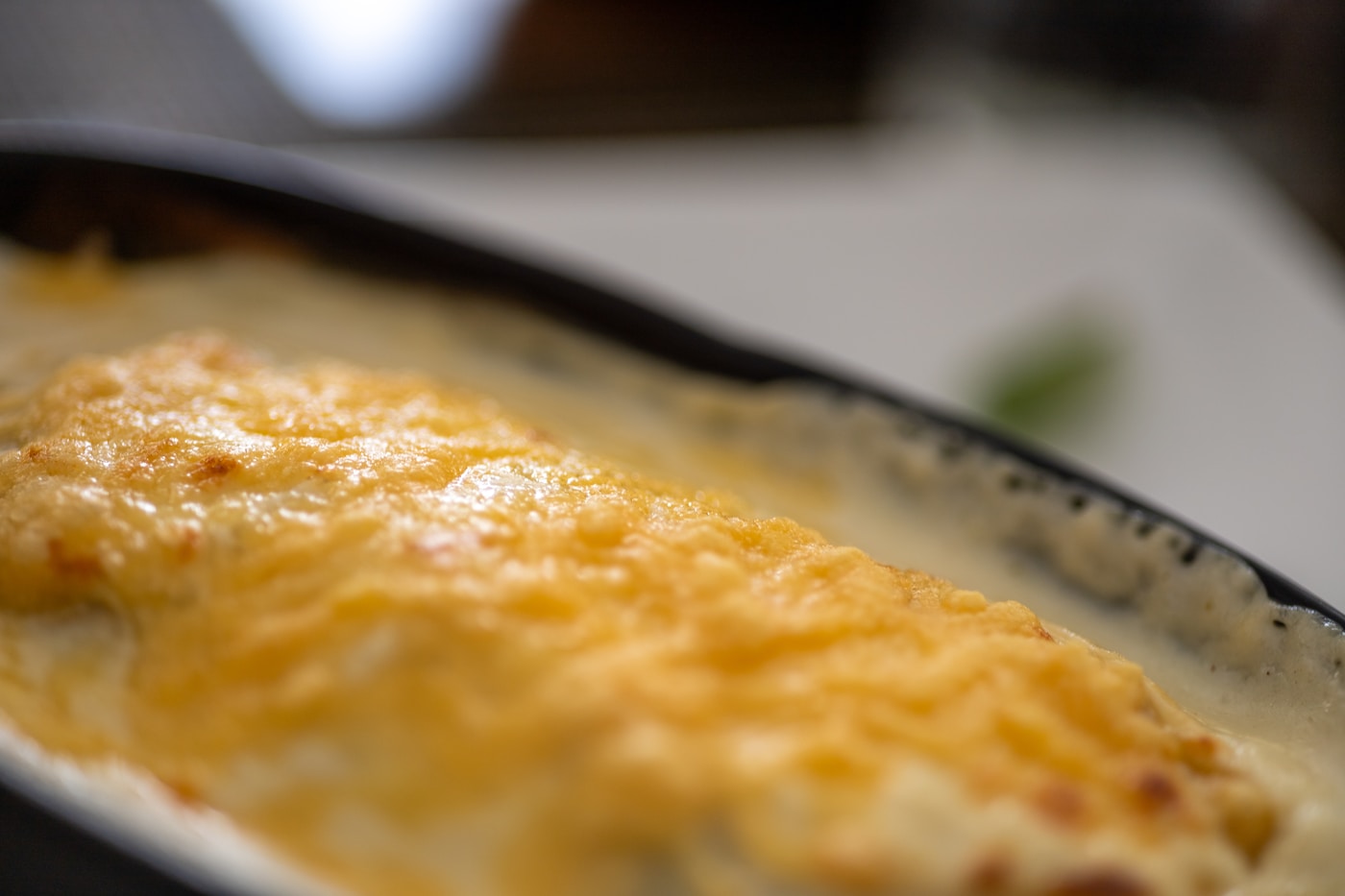 Bubbly melted cheese baked golden brown in a dish