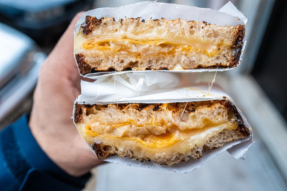 Melted cheese pulling from a sandwich