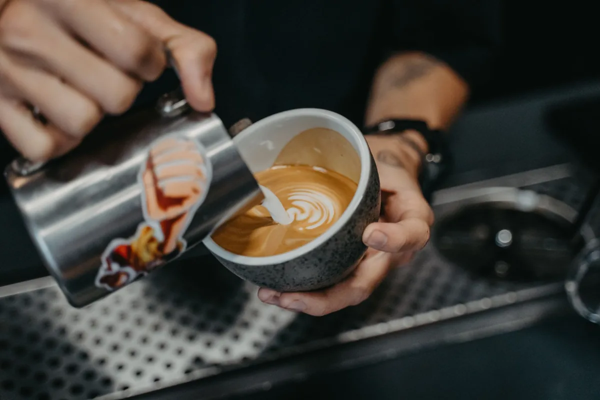 Milk being poured into coffee