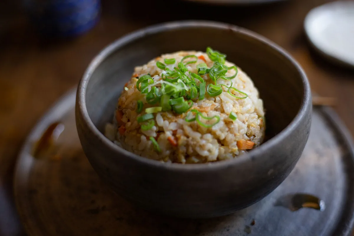 Fried rice bowl garnished with fresh herbs
