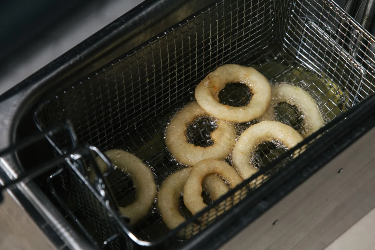 Onion rings frying in hot oil