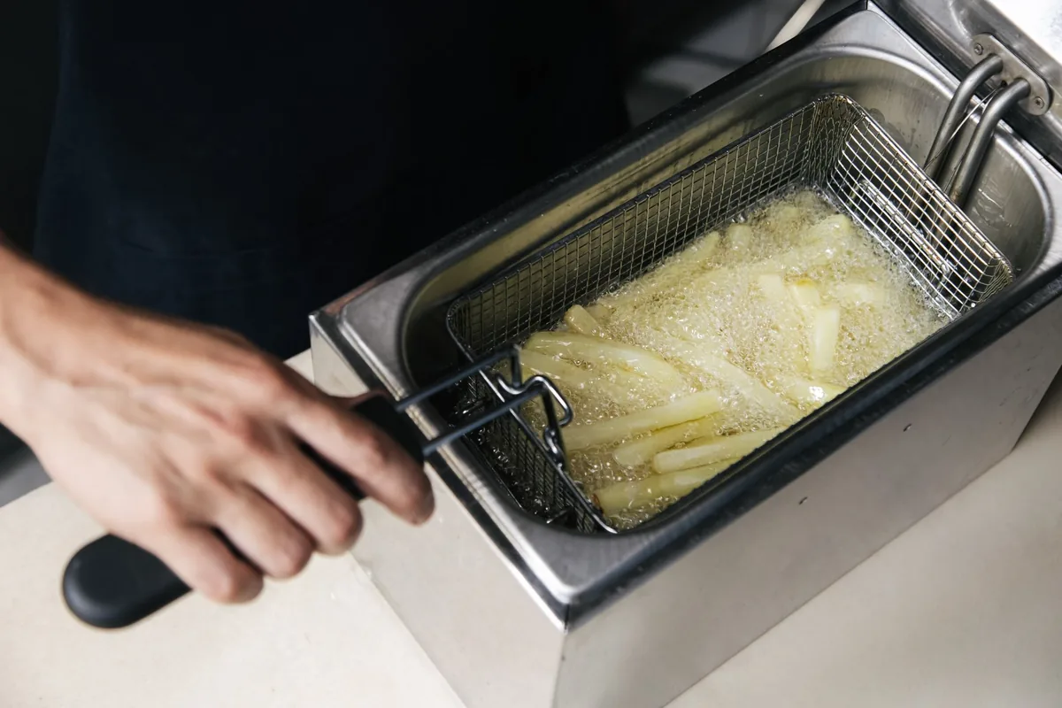 Operating a deep fryer cooking french fries