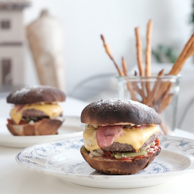 Bacon cheeseburger with melted cheese on a decorative plate