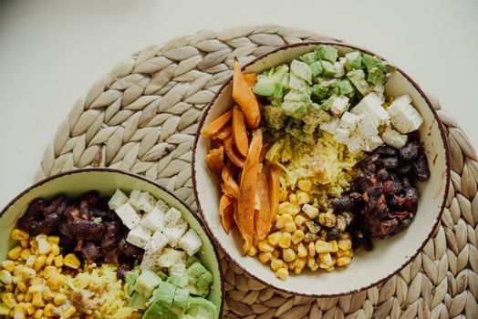 Black beans, corn, and avocado toppings in bowls