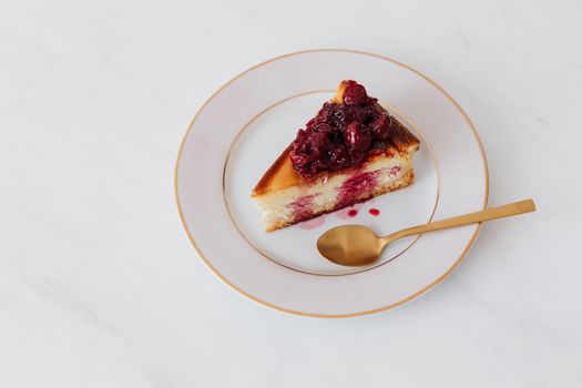 Berry-topped cheesecake slice on an elegant plate