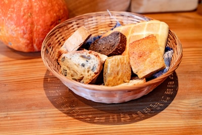 Basket of assorted bread on a wooden table