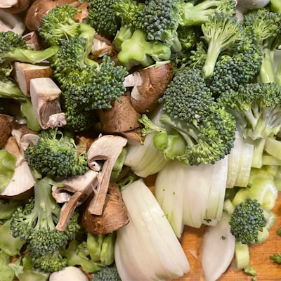Fresh broccoli florets on a wooden cutting board