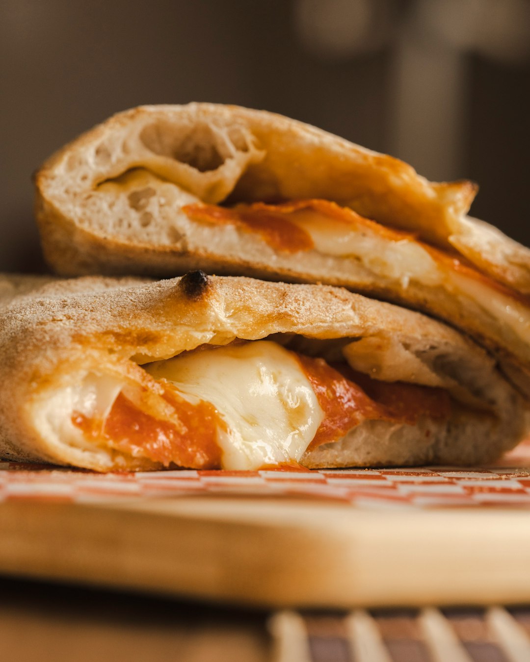 Sliced calzone with melted cheese pulling apart, marinara filling visible