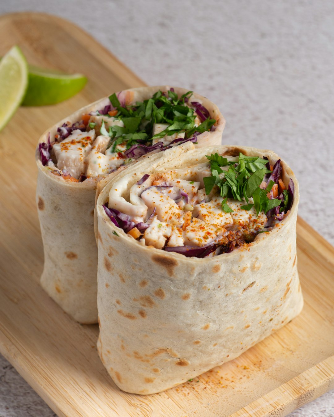Chicken wrap sliced in half showing filling