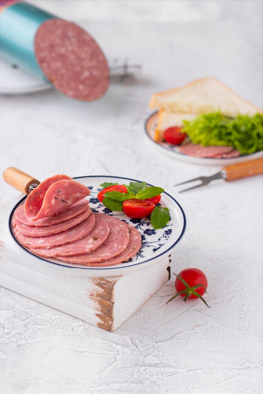 Sliced salami with fresh tomato and lettuce