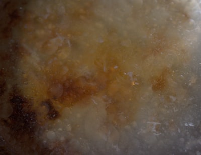 Close-up of onions caramelizing in a pan