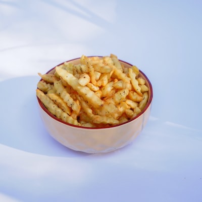 Seasoned cheese fries in a bowl