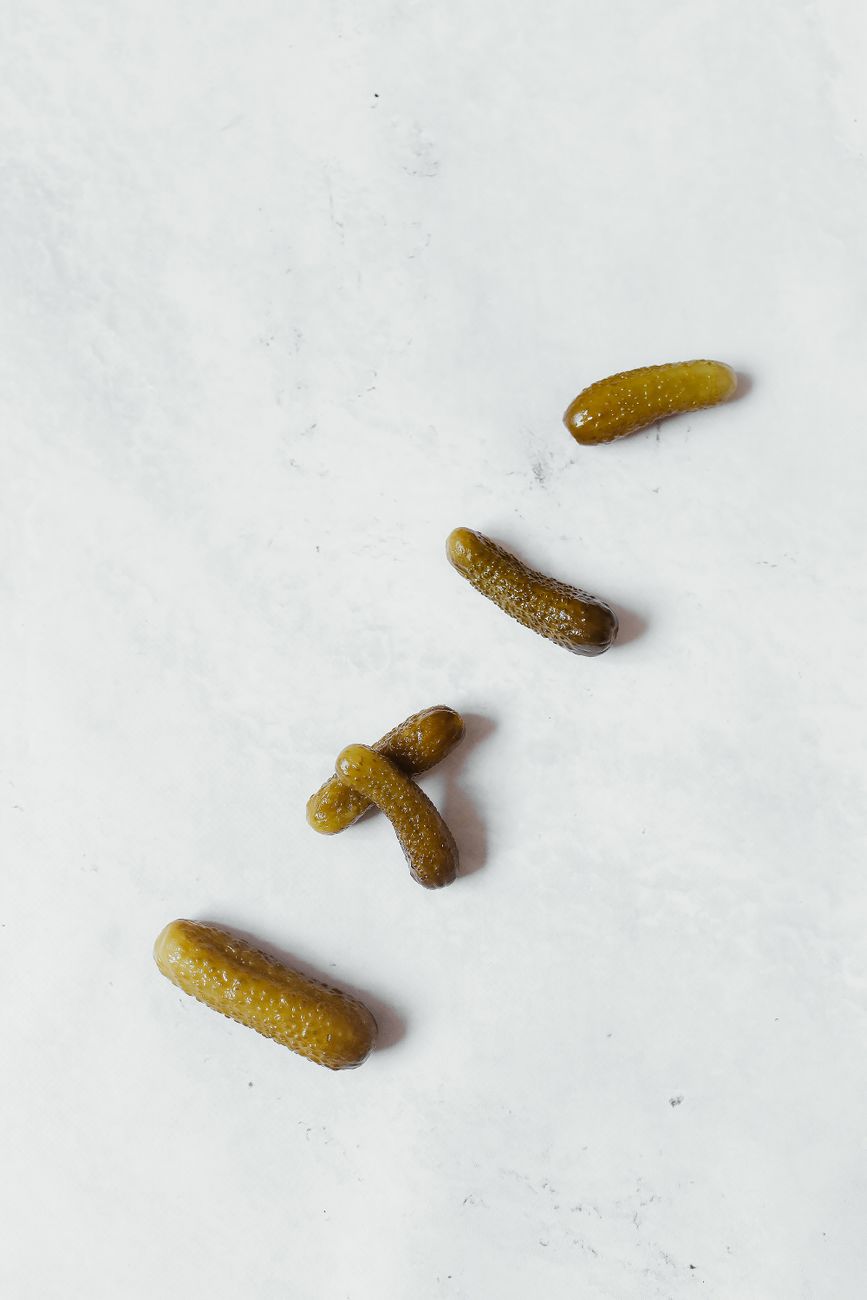 Whole pickles on a light surface
