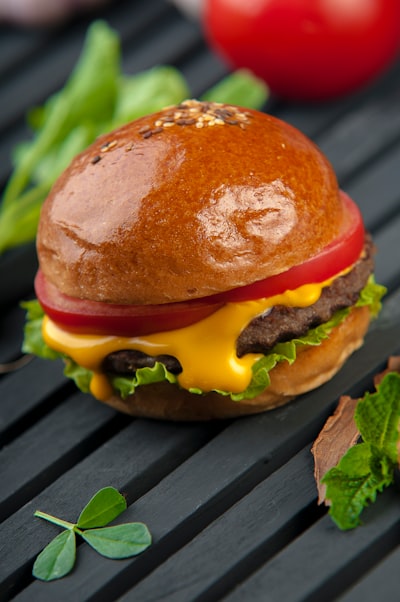 Cheeseburger with melted cheddar, lettuce, and tomato