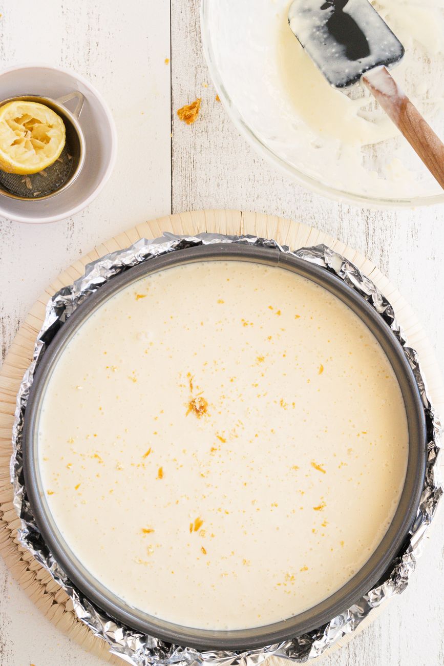 Cheesecake batter in a baking pan before baking