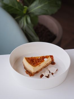 Elegant slice of cheesecake on a white plate