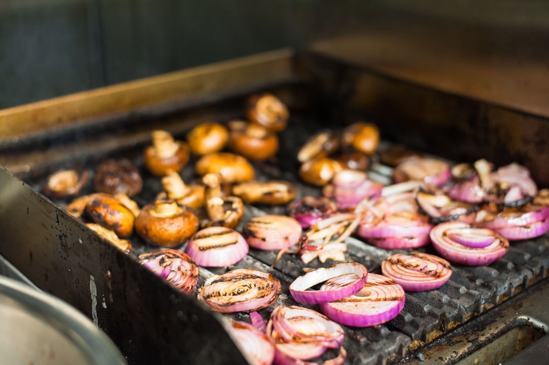 Grilled onions and mushrooms on a griddle