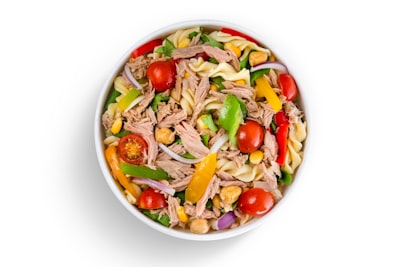 Chef salad with sliced meats, tomatoes, and peppers