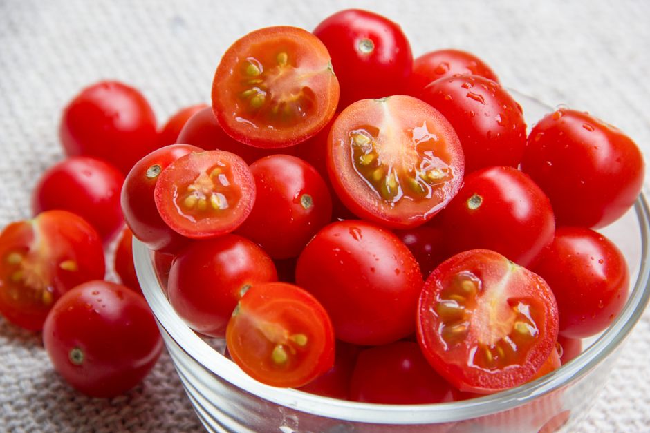 Halved cherry tomatoes in a glass bowl