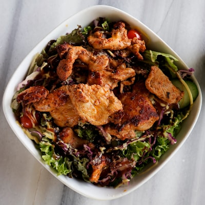 Chicken Caesar salad with grilled chicken over greens