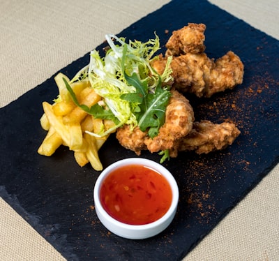 Breaded chicken nuggets with fries and dipping sauce