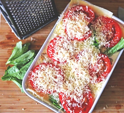 Sliced tomatoes topped with melted cheese and basil