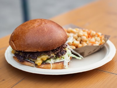 Classic cheeseburger with melted cheese on a plate with a side dish