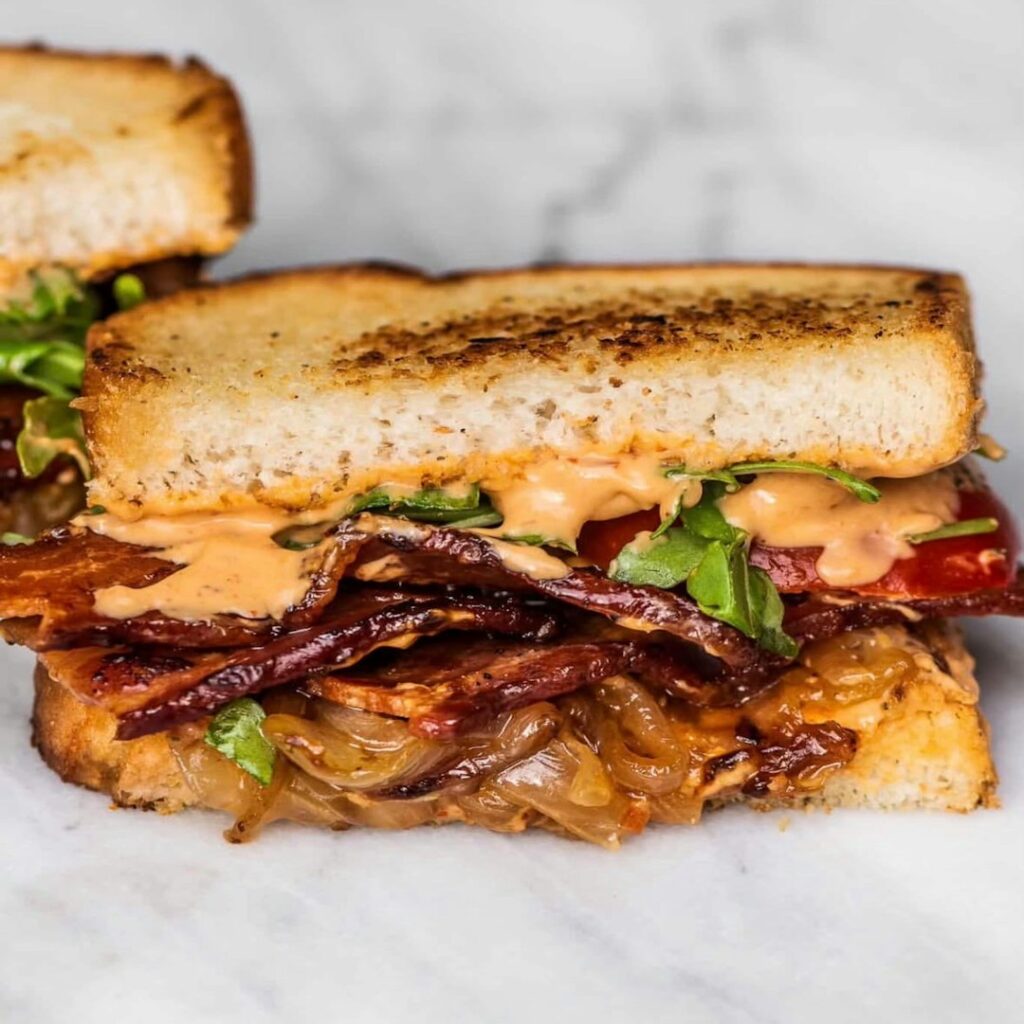 Classic Philly cheesesteak sandwich with caramelized onions and melted cheese