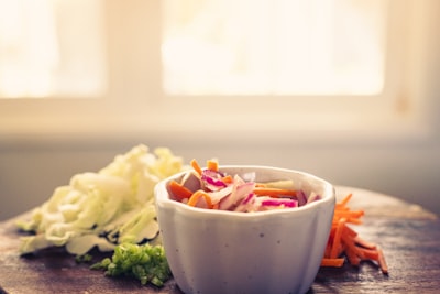 Bowl of fresh coleslaw with shredded cabbage and carrots