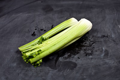 Fresh celery sticks on a dark background