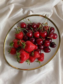 Fresh cherries and strawberries on a plate