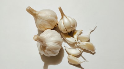 Fresh garlic bulbs and cloves on a white background