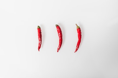 Fresh red chili peppers on a white background