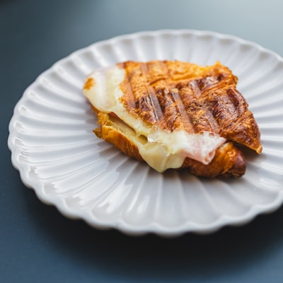 Toasted bread with melted cheese on a white plate