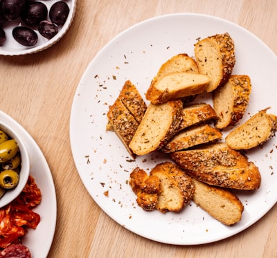 Sliced toasted garlic bread with herbs on a plate