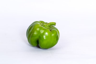 Fresh green bell pepper on a white background