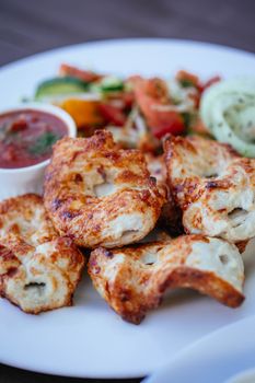 Grilled chicken pieces on a white plate