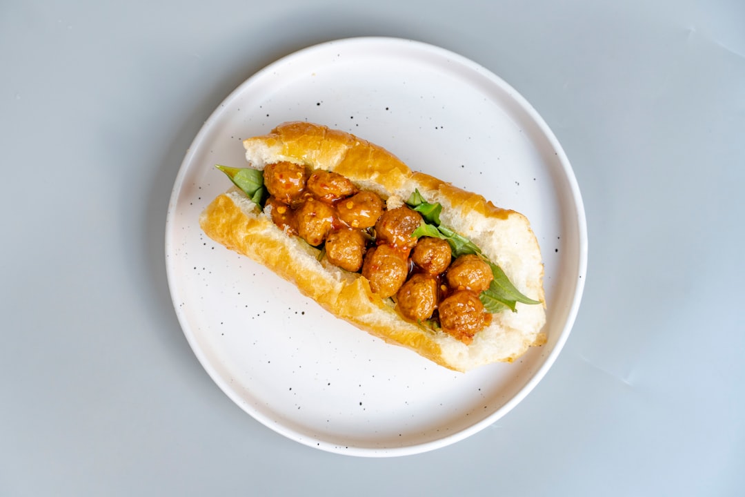 Meatball sub sandwich on a white plate