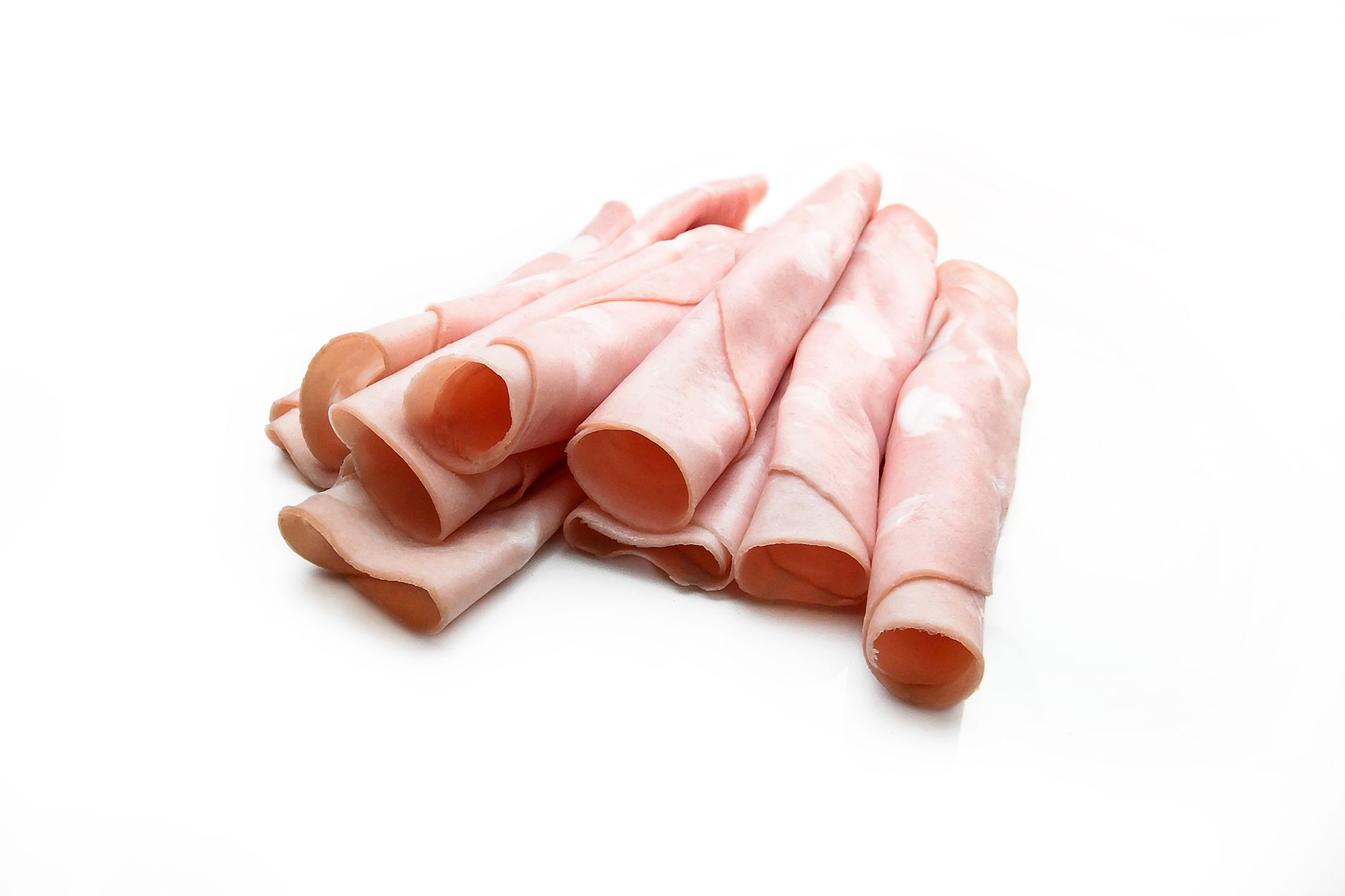 Rolled ham slices on a white background