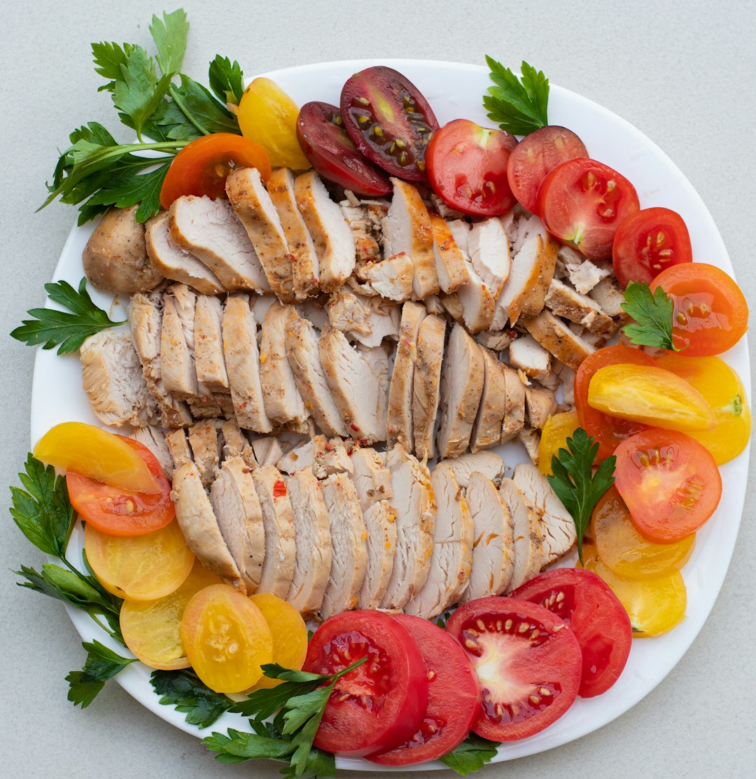 Sliced turkey with fresh tomatoes on a plate