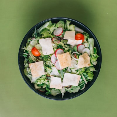 Fresh house salad with lettuce, tomato, and pita croutons