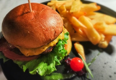 Loaded burger with lettuce, tomato, and bacon, served with fries