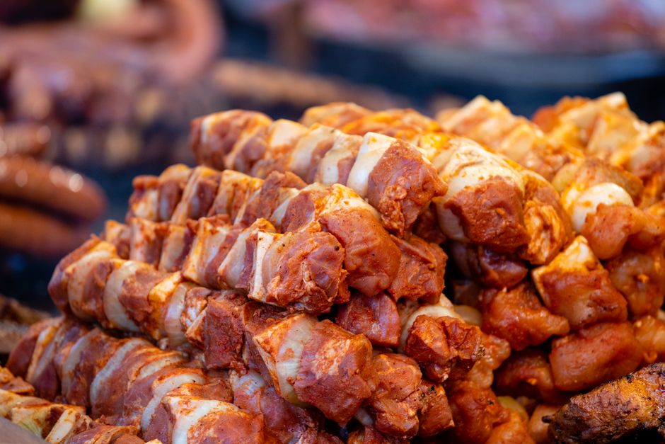 Marinated pork skewers stacked and ready for grilling