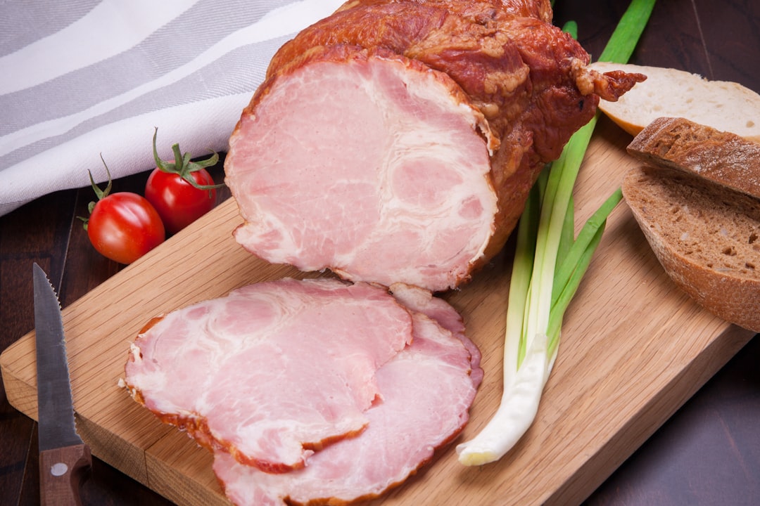 Sliced ham on a wooden cutting board
