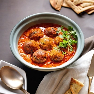 Meatballs in marinara sauce with fresh herbs