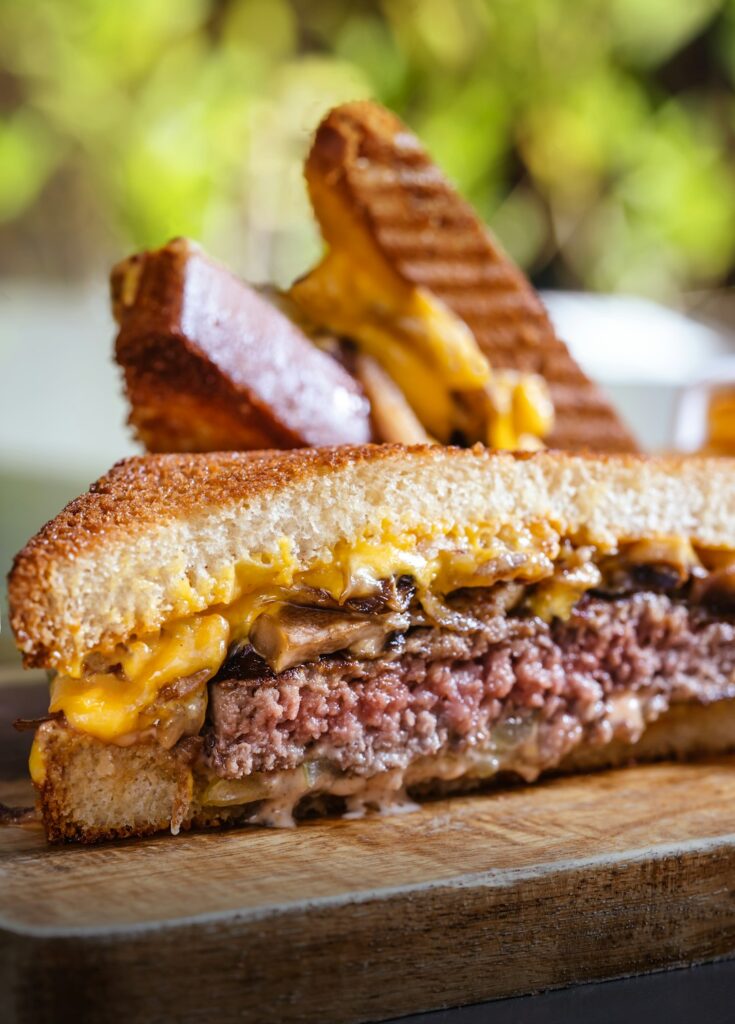 Mushroom cheesesteak sandwich with melted cheddar and sauteed mushrooms