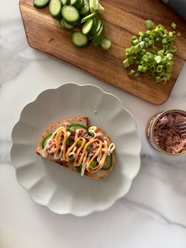 Open-faced tuna sandwich with cucumber and green onion